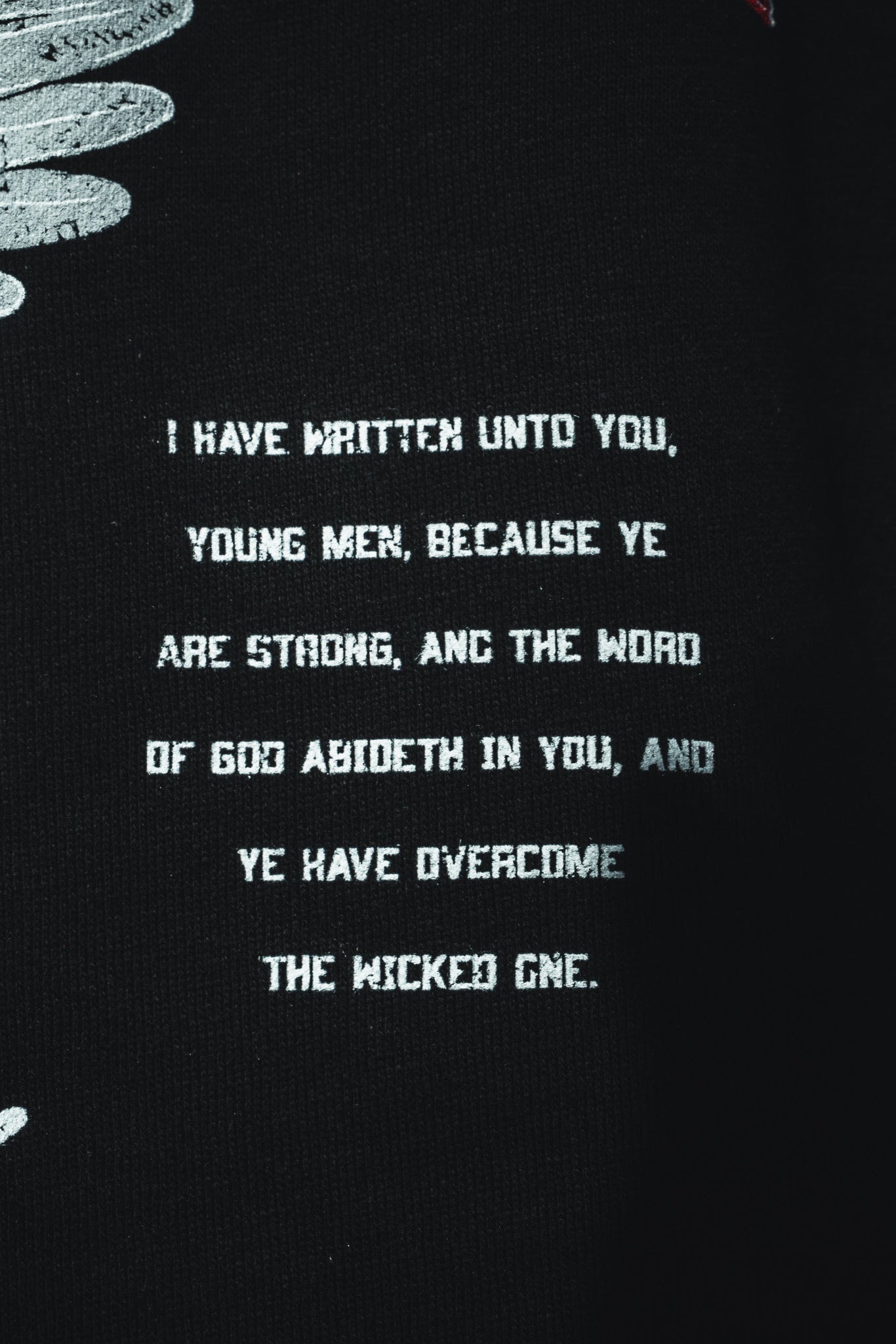 The 13th Overcome Premium Hoodie features white text on black: "I have written unto you, young men, because ye are strong..." (John 2:14), with partial white feather designs on the left.