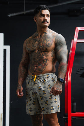 Man with tattoos standing in a gym setting