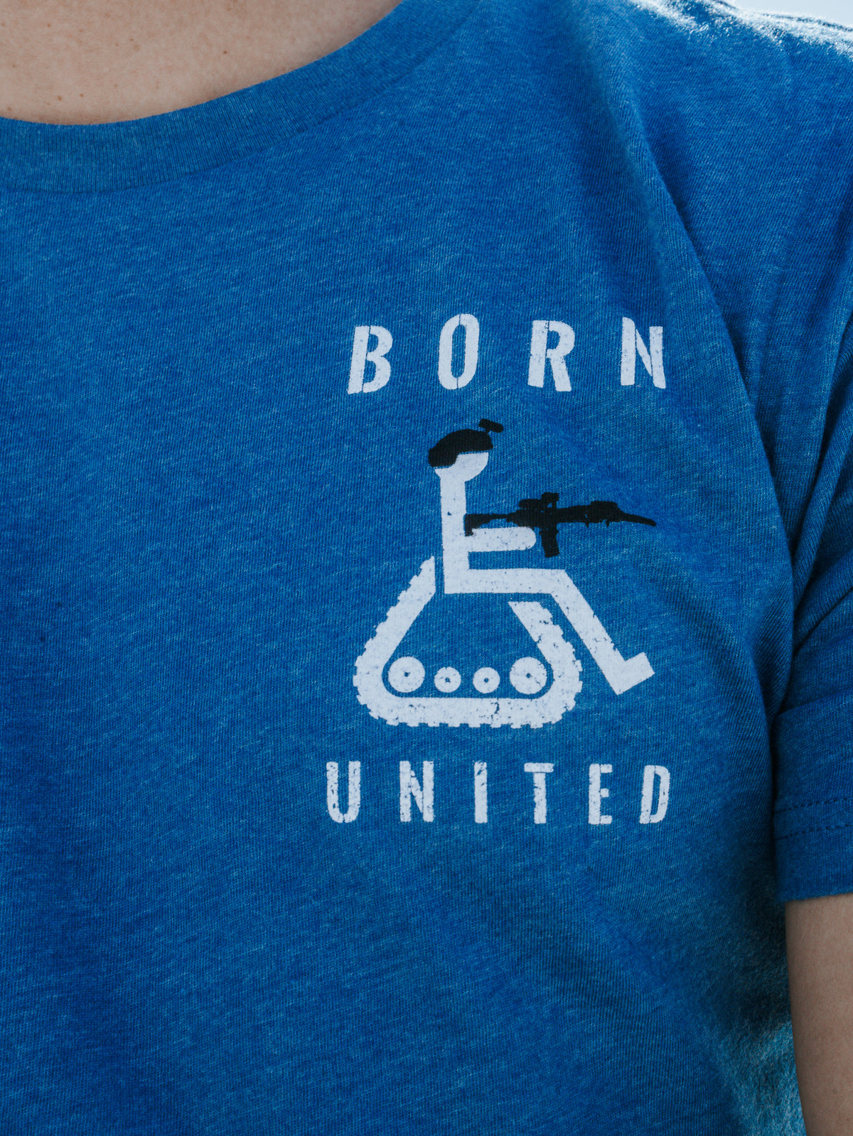 A person is wearing the Disabled Vet - Blue t-shirt by Born United Private Label, showcasing a disgruntled wheelchair symbol with tank tracks and a figure with a rifle, along with the words BORN and UNITED boldly printed above and below.