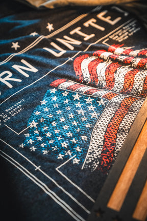 A close-up of the Born United Private Label Limited Edition Tee from the Born United Patriot Box, featuring a stylized American flag—ideal for America's 250th Birthday or your Patriot Box collection.