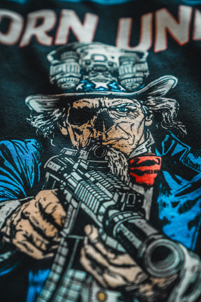Comic-style Uncle Sam in skull mask and goggles, holding a rifle with bold text above. Celebrate America's 250th Birthday with Limited Edition Born United Patriot Box tees by Born United Private Label!.