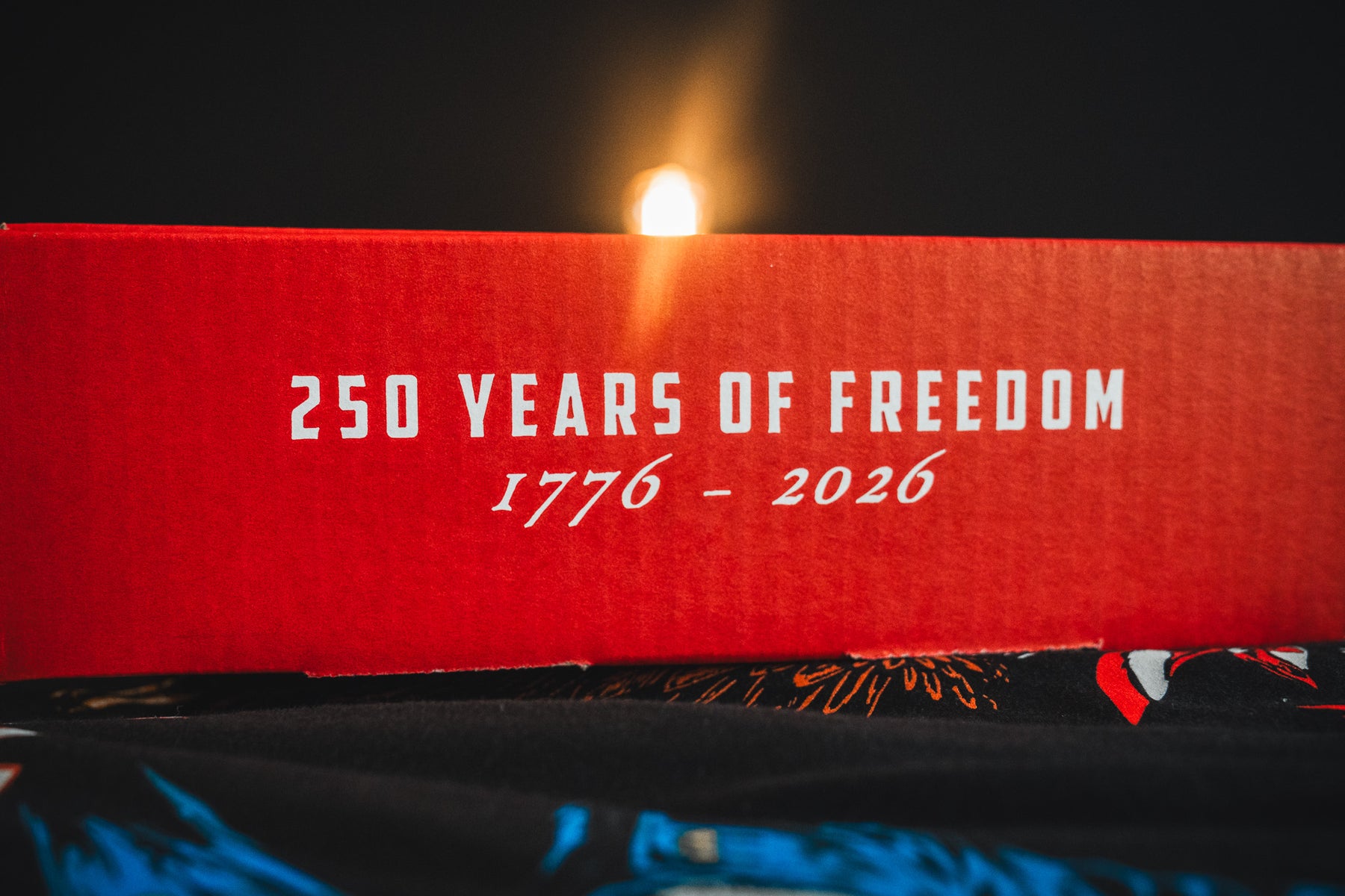 A red Born United Patriot Box by Born United Private Label shows "250 YEARS OF FREEDOM 1776 - 2026" in white letters, lit against a dark background—celebrating America’s 250th Birthday.