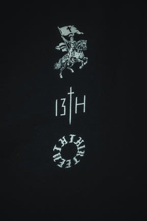 The Kingdom Over Everything Premium Tee by 13th features a bold white graphic of a knight on horseback with a flag, sword-inspired "T" in the logo, and circular design—reflecting the pursuit of God's kingdom above all.