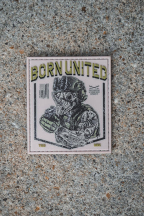 A TacRhino PVC Patch from the Born United Private Label features a heavily armed soldier on a speckled 3x3 Velcro-backed surface, with "BORN UNITED" text above and surrounded by various symbols and detailed text.