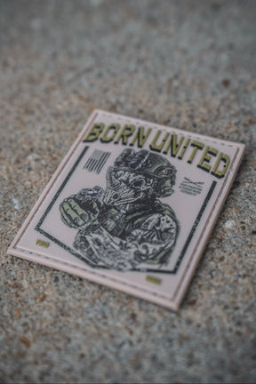 A 3x3 inch square TacRhino PVC patch from Born United Private Label, designed for Velcro attachment on concrete, features a helmeted soldier graphic and the text "BORN UNITED" at the top.