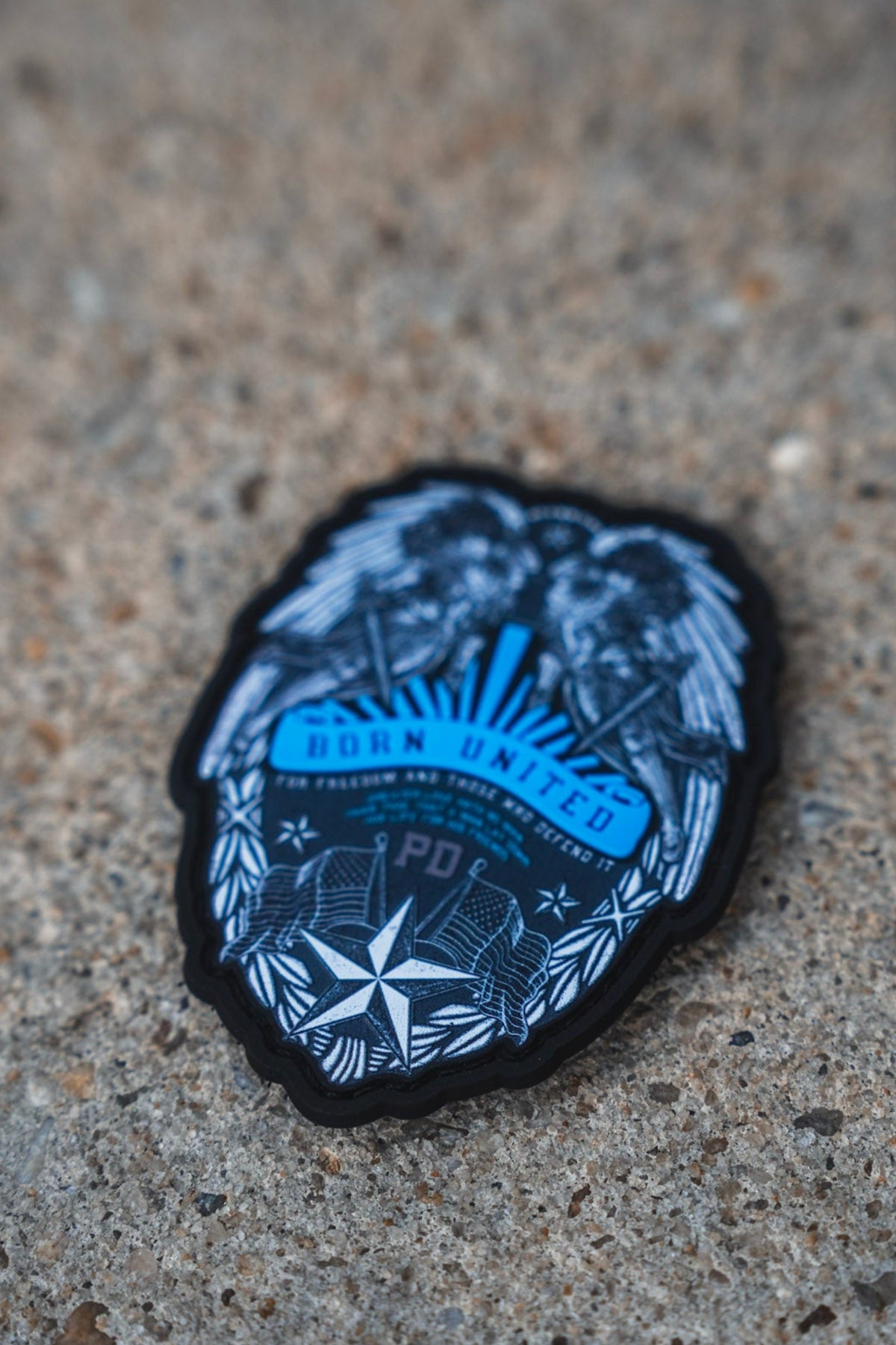 A circular embroidered patch featuring a blue and white police badge design with the text 'POLICE DEPARTMENT' and 'P.D.