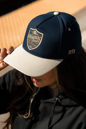 relentless betrayal - unisex og navy snapback hat on model