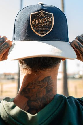 relentless betrayal - og navy curved brim snapback hat on model