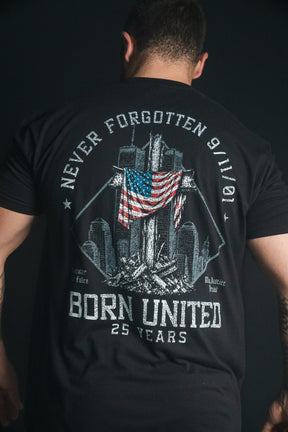 A person wearing the Born United Private Label “We Remember: 25th Anniversary” tee—a black remembrance shirt featuring a 9/11 memorial graphic, American flag, and the text “Never Forgotten 9/11/01” and “Born United 25 Years” on the back. This powerful tribute honors resilience and commemorates the legacy of September 11.
