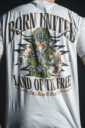 Wearing the “Freedom Frontier” T-shirt from Born United Private Label—featuring the phrases Born United, Land of the Free, Let’s Keep It That Way and a striking illustration of an armored longhorn wielding guns—is a bold display of American values and patriotism.
