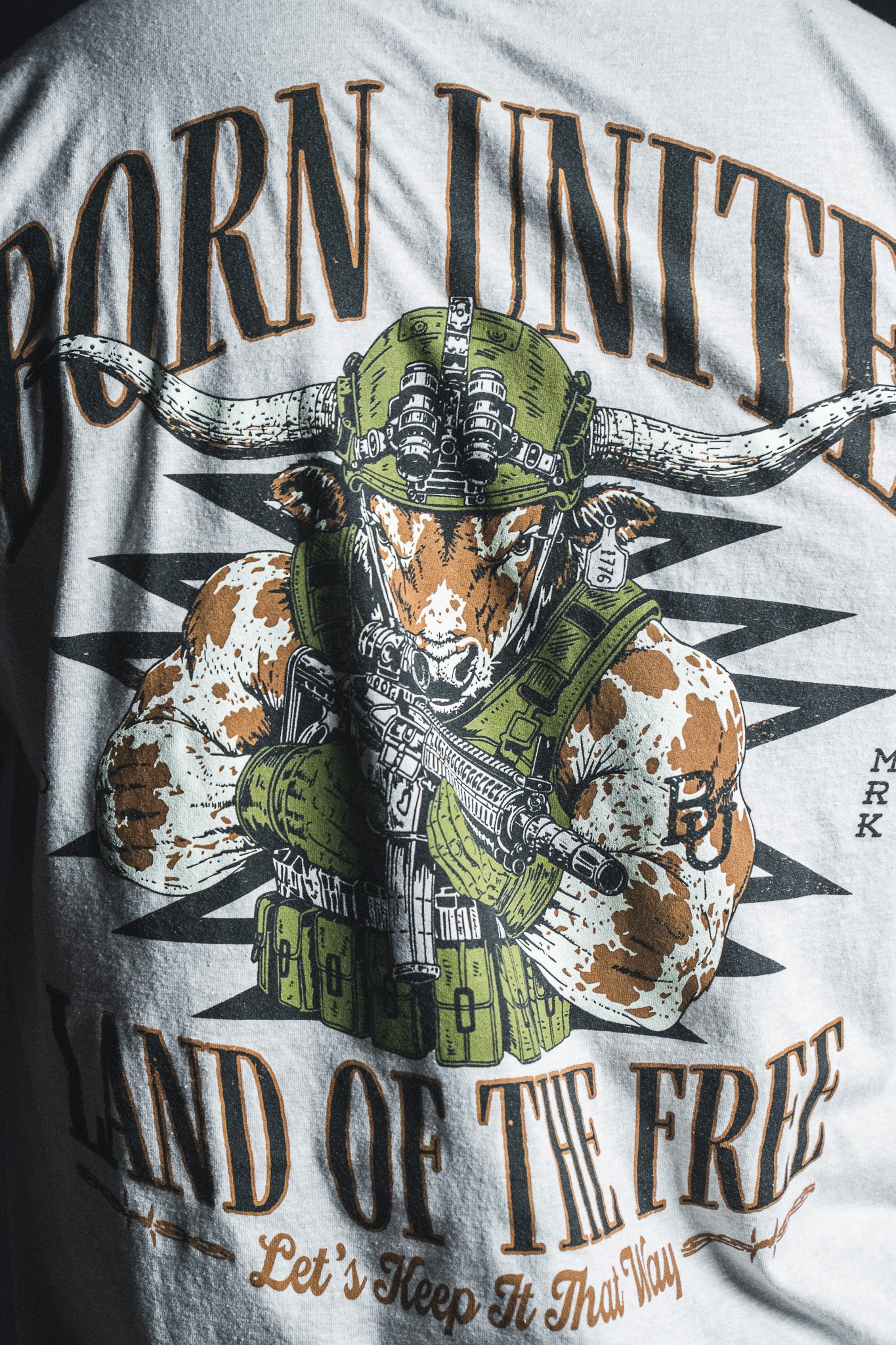 Introducing the “Freedom Frontier” graphic T-shirt by Born United Private Label—a bold statement piece featuring an armored longhorn wielding a rifle and the empowering text, “BORN UNITED, LAND OF THE FREE, Let’s Keep It That Way.” Celebrate freedom and American values in style.