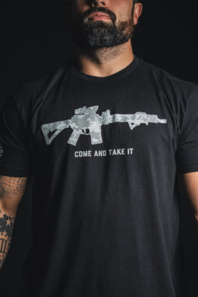 A man wearing the Born United Private Label “Come and Take It” black tee, which features a graphic of a rifle with the bold text “COME AND TAKE IT” printed below—a statement piece for 2nd Amendment pride.