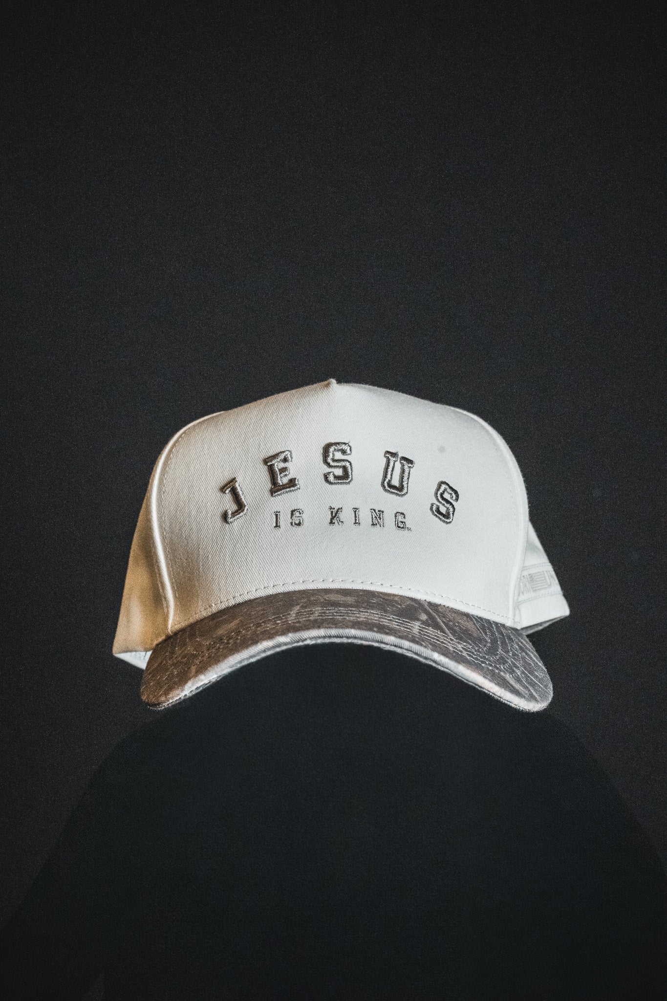 Introducing the Jesus is King - Ivory and Deadwood Camo Snapback by Born United Private Label, featuring bold “JESUS IS KING” embroidery on the front. Set against a dark background, this eye-catching cap is ideal for anyone wanting to make a powerful statement of faith.