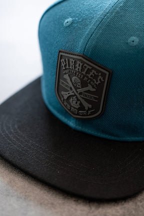 relentless betrayal - pirate patch teal snapback