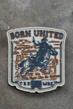 The Outlaw PVC Patch by Born United Private Label shows a cowboy on horseback with cacti, plus “BORN UNITED” and “Everyone’s An Outlaw. It’s Time To Fight Like An Outlaw. TRD MRK.” in bold text.