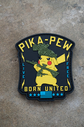 The Pika Pew PVC Patch by Born United Private Label features Pikachu with a rifle and tactical helmet, plus "PIKA-PEW," "LIVE FREE," and "BORN UNITED" text—perfect for fans with a Gotta Catch 'em All spirit.