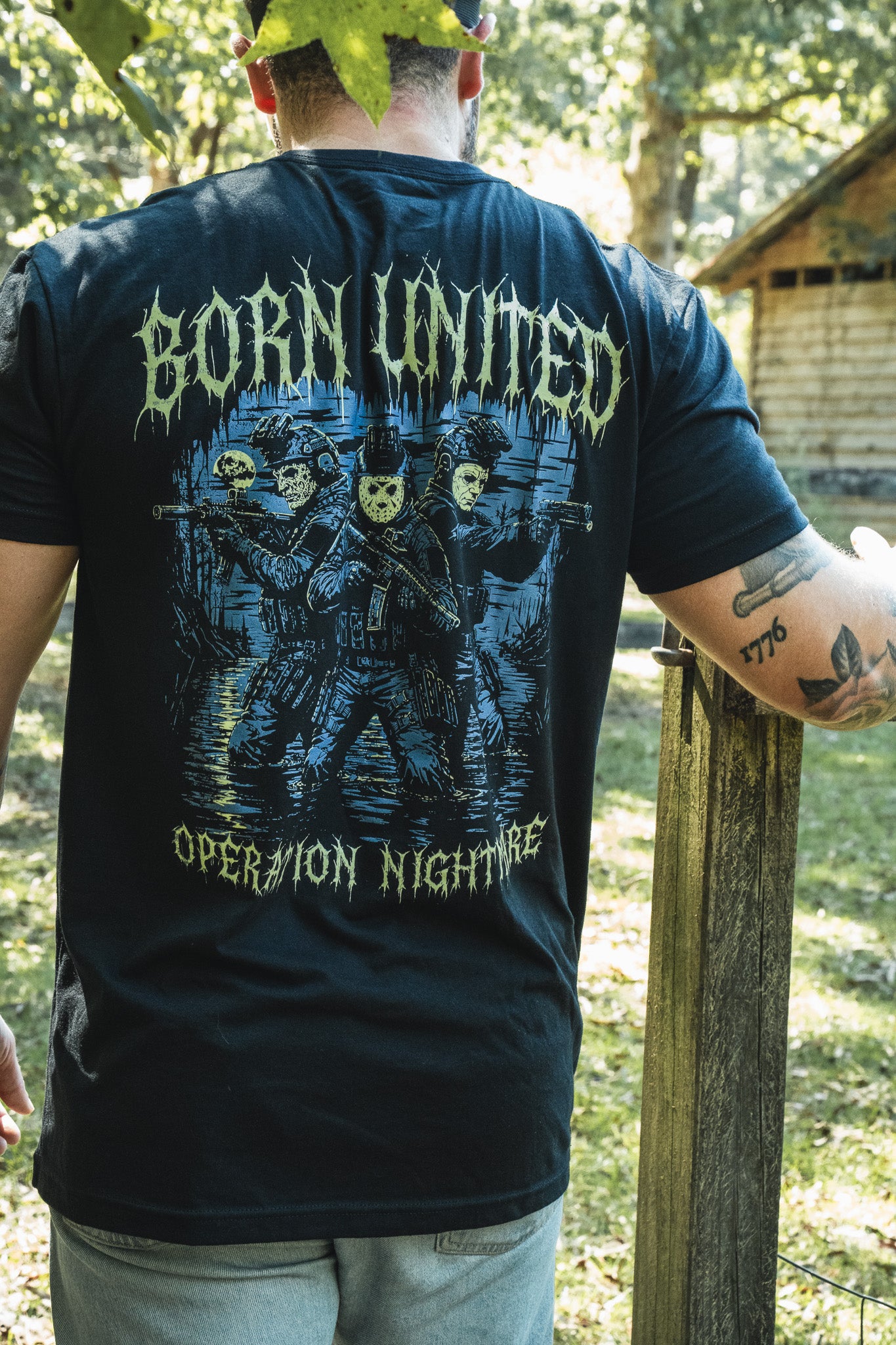 Operation Nightmare Tee - Glow in the Dark black premium cotton t-shirt featuring a glow-in-the-dark graphic of three soldiers in skull masks holding rifles, with text above and below the design.