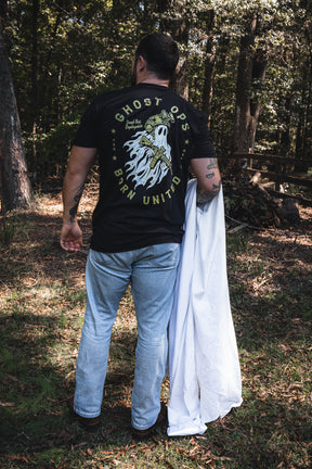 A man wearing a Born United Ghost Ops Tee featuring a ghost in tactical gear holding a rifle, with the text Ghost Ops and Born United.