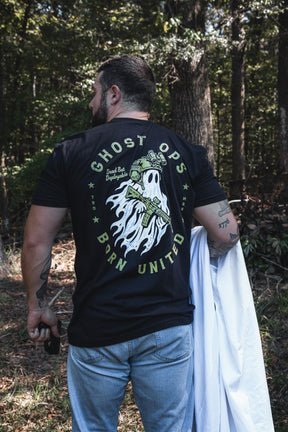 A man wears a Born United Private Label Ghost Ops Tee featuring a tactical ghost soldier with a rifle and the text Dead But Deployable.