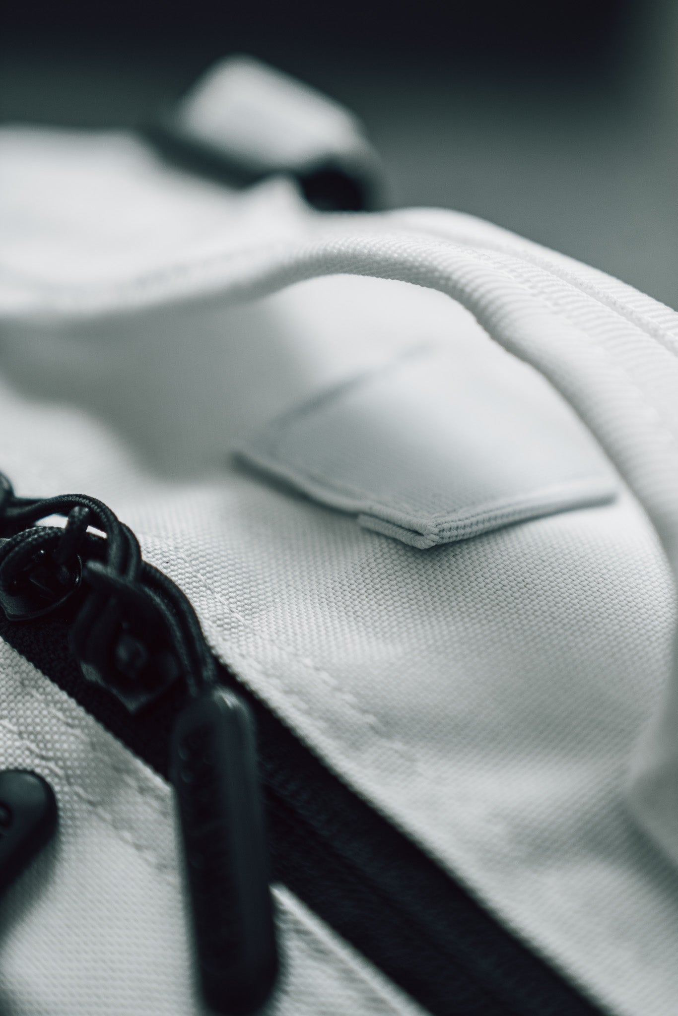 Close-up of the Born United Private Label Storm Trooper Tac-Pac - 45L, a white fabric bag with black zipper and handle, featuring textured material and stitching. The Star Wars-inspired design captures Stormtrooper elegance in every detail.