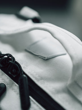 Close-up of the Born United Private Label Storm Trooper Tac-Pac - 45L, a white fabric bag with black zipper and handle, featuring textured material and stitching. The Star Wars-inspired design captures Stormtrooper elegance in every detail.
