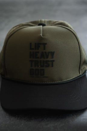 Introducing the Lift Heavy. Trust God. Hydro - OD Green Snapback Hat by Tango Charlie Apparel—a sweat-resistant gym hat in striking OD green and black, featuring “LIFT HEAVY TRUST GOD” boldly printed in black on the front panel. Perfect for showcasing your faith and commitment during every workout.