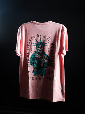 The Liberty Or Death- Heather Pink t-shirt by Born United Private Label features a skeletal Statue of Liberty with rifle and bold “Give Liberty Or Give Me Death” text—a striking, patriotic statement piece against a dark background.