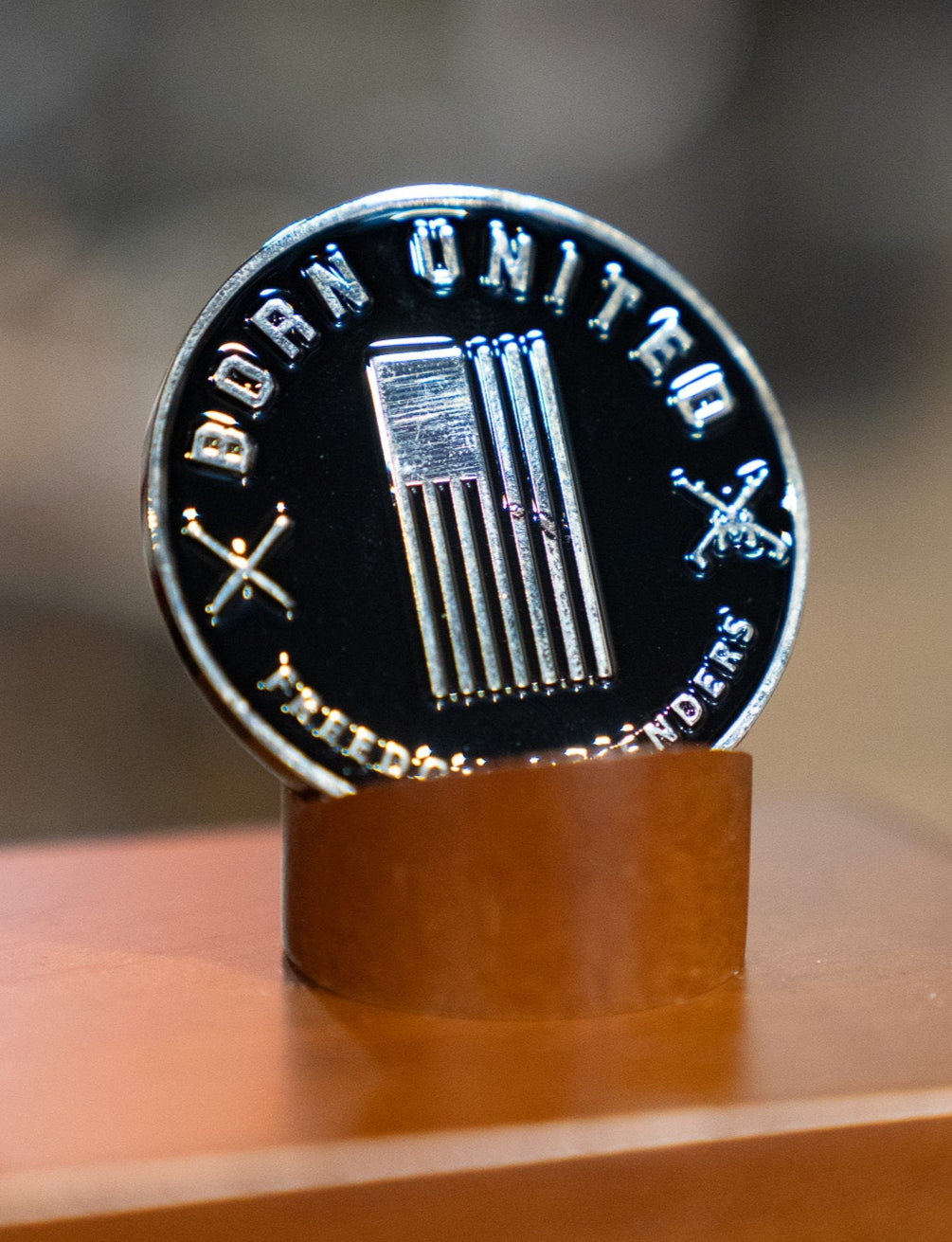 The Pika-Pew Challenge Coin by Born United Private Label features black and silver tones, a stylized American flag, “BORN UNITED,” crossed swords, and “FREEDOM DEFENDERS” on the edge—a bold collectible tribute.