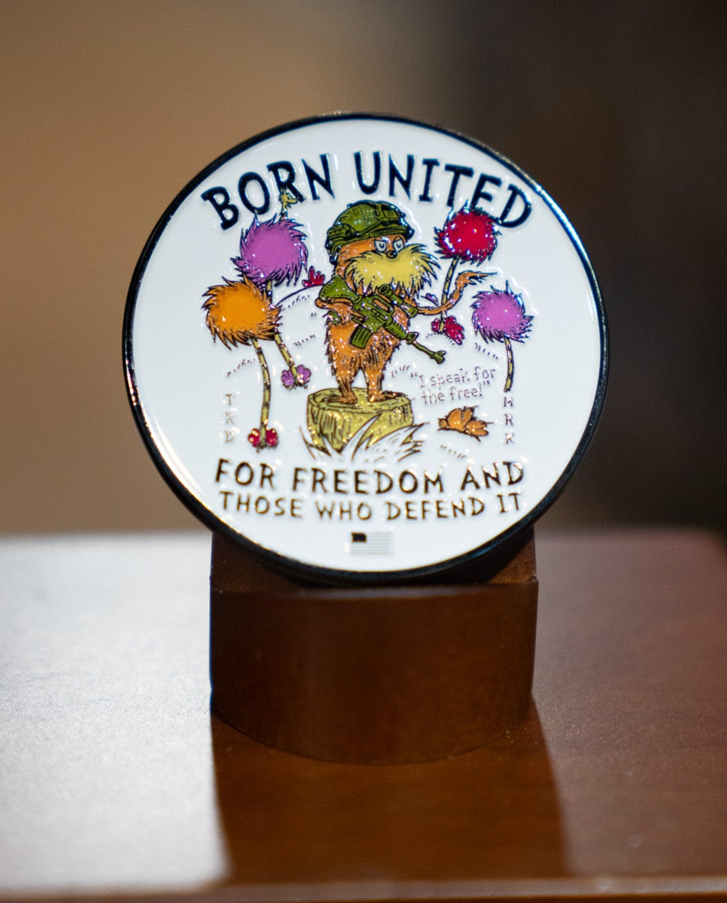 Showcasing the Speak for the Free! Challenge Coin by Born United Private Label, this round coin features the Lorax among truffula trees with "BORN UNITED FOR FREEDOM AND THOSE WHO DEFEND IT" and "Speak for the Free" highlighted.