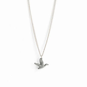The Mucker Bucket Duck It Silver Necklace features a detailed stainless steel flying duck pendant with outstretched wings on a delicate chain, elegantly set against a plain white background. Made in the USA.
