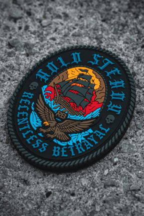 The Hold Steady Patch by Relentless Betrayal is a round 3x3 design on gray textured fabric, showing a ship and eagle, with "HOLD STEADY" at the top and "RELENTLESS BETRAYAL" below in bold blue letters.