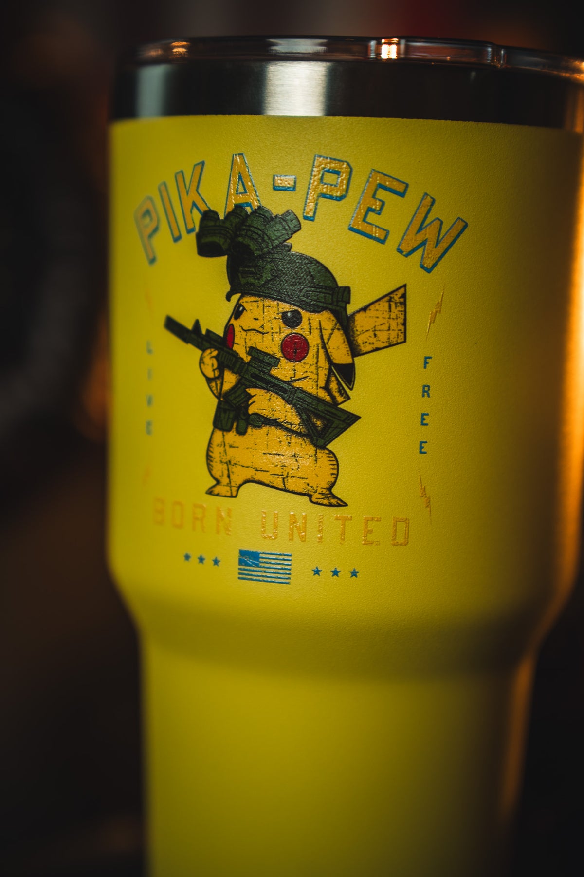 The 30oz Pika-Pew Tumbler by Born United Private Label features Pikachu as a soldier with a rifle, “PIKA-PEW” above, “BORN UNITED” below, plus a small American flag and stars.