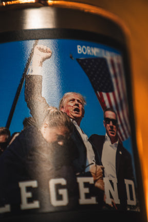 A close-up of the Born United Private Label "Forever Legend Tumbler - 30oz" featuring a man in a suit raising his fist, an American flag backdrop, and "LEGEND" partially visible at the bottom.