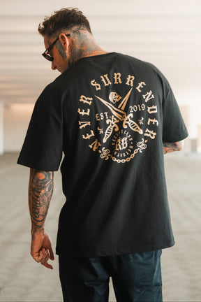 A tattooed man in sunglasses faces away, wearing the Relentless Betrayal Never Surrender Premium Oversized Ghost T-Shirt—a black heavyweight tee with crossed swords and bold gold “Never Surrender, EST 2019” lettering on the back.