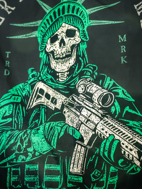 Born United Private Label’s Liberty or Death Flag features a skeleton in tactical gear with a helmet resembling the Statue of Liberty’s crown, holding a rifle in green and white against a dark background.