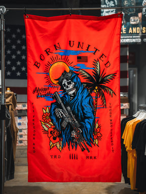 The Always Deadly Flag by Born United Private Label features a grim reaper in a blue hood with a rifle on a red banner, plus sun, palm tree, and American flag accents. "Born United" and "Always Deadly" highlight its patriotic military design.