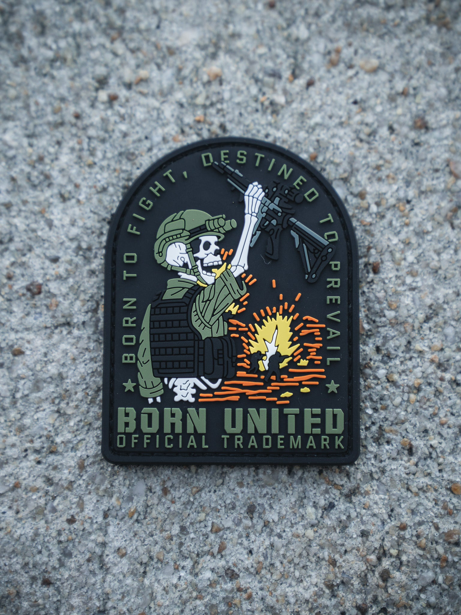 The Destined to Prevail PVC Patch by Born United Private Label shows a skeleton soldier in tactical gear firing a rifle with sparks. The patch features the slogans: BORN TO FIGHT, DESTINED TO PREVAIL, and BORN UNITED OFFICIAL TRADEMARK.