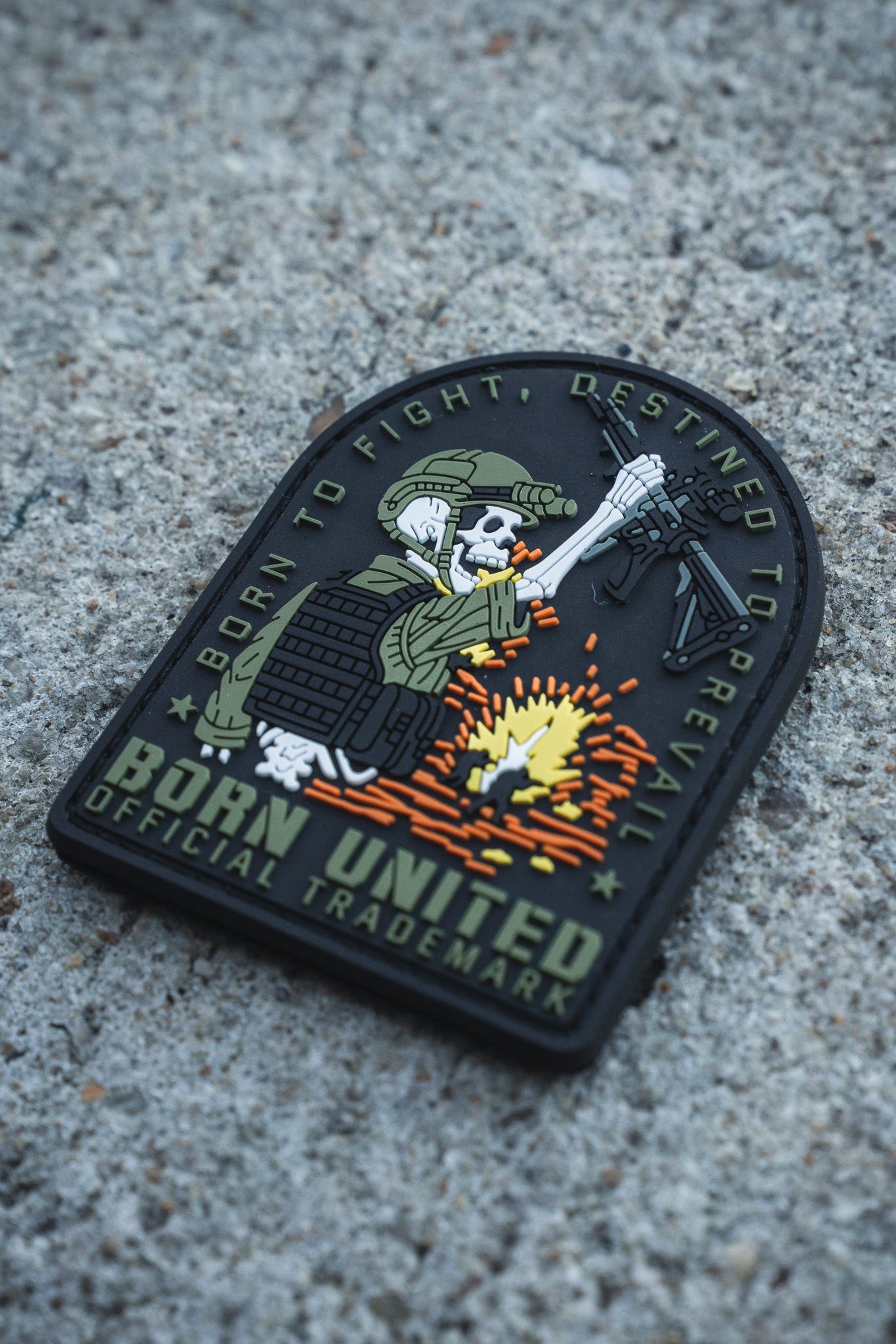 The Destined to Prevail PVC Patch by Born United Private Label features a skeleton soldier in tactical gear firing a rifle, with the words: "Born to Fight, Destined to Prevail. Born United. Official Trademark.