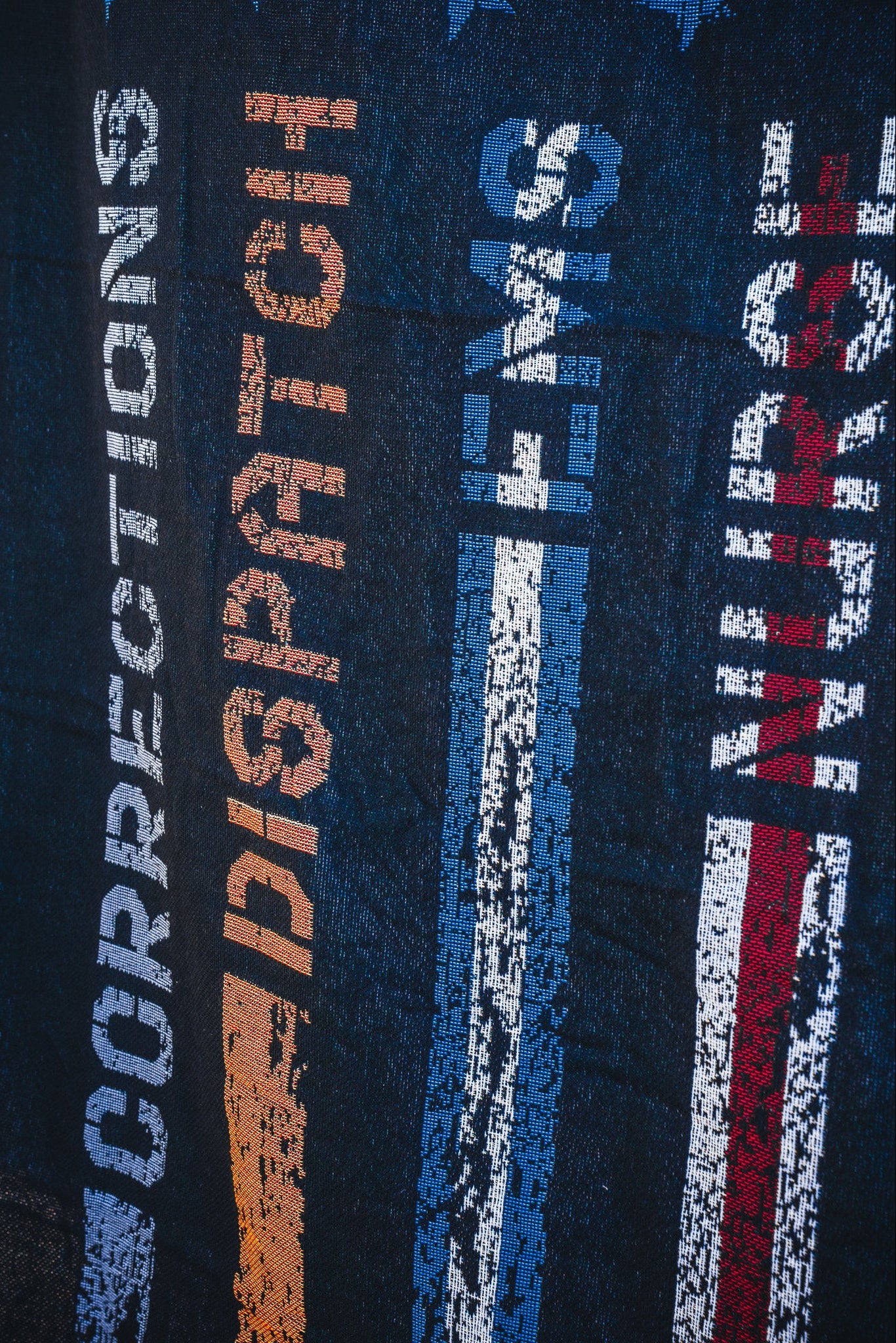 The American Heroes Jacquard Blanket by Born United Private Label features woven vertical stripes and the words CORRECTIONS (blue), DISPATCH (orange), EMS (blue), and NURSE (red) to honor emergency services.