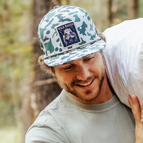 mucker bucket - "wild bacon" old school camo hog bucket on model front