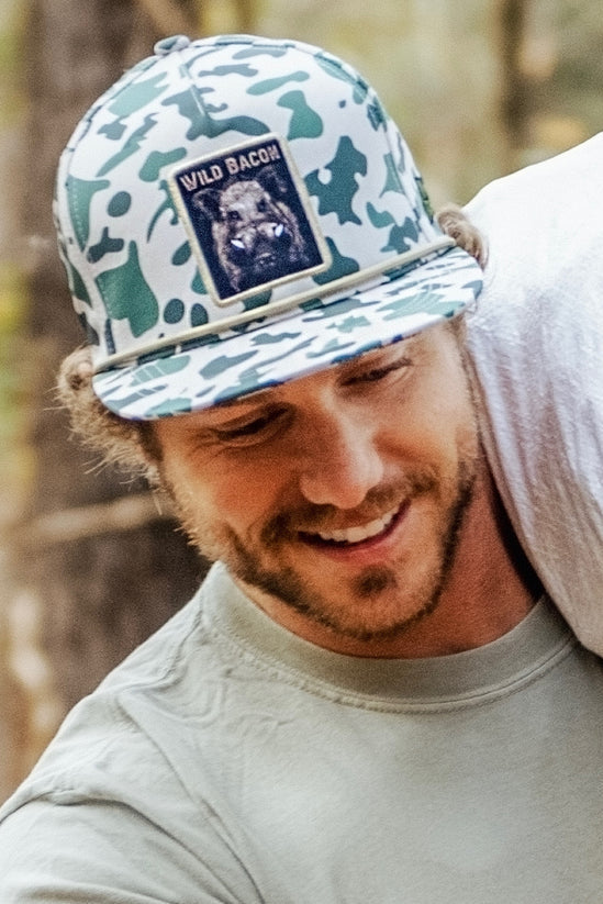 mucker bucket - "wild bacon" old school camo hog bucket on model front