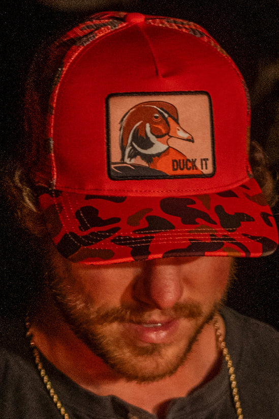 mucker bucket - "duck it" orange camo trucker bucket on model