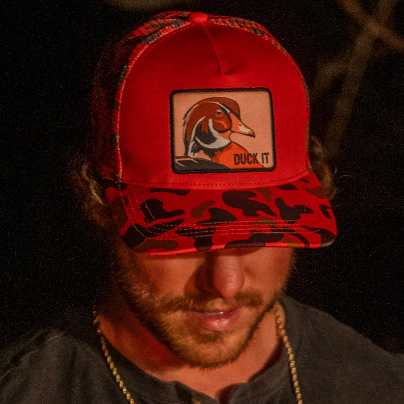 mucker bucket - "duck it" orange camo trucker bucket on model