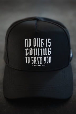 The Tango Charlie Apparel No One Is Coming To Save You Hydro Snapback Hat is black and breathable, featuring white gothic text—"No one is coming to save you. Be your own hero."—against a dark background.