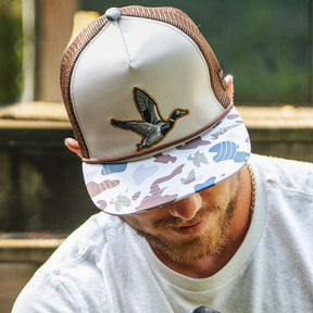 mucker bucket - camo duck bucket hat on model front