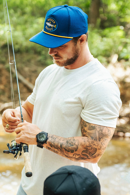 mucker bucket - rainbow trout blue fishing hat on model
