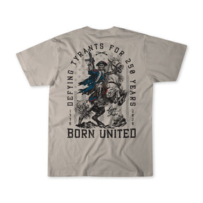 Celebrate American resilience in the Born United Private Label 250th Anniversary Tee, featuring a colonial-era figure and the text: Defying Tyrants for 250 Years, 1776-2026, Born United, Live Free. Limited edition.