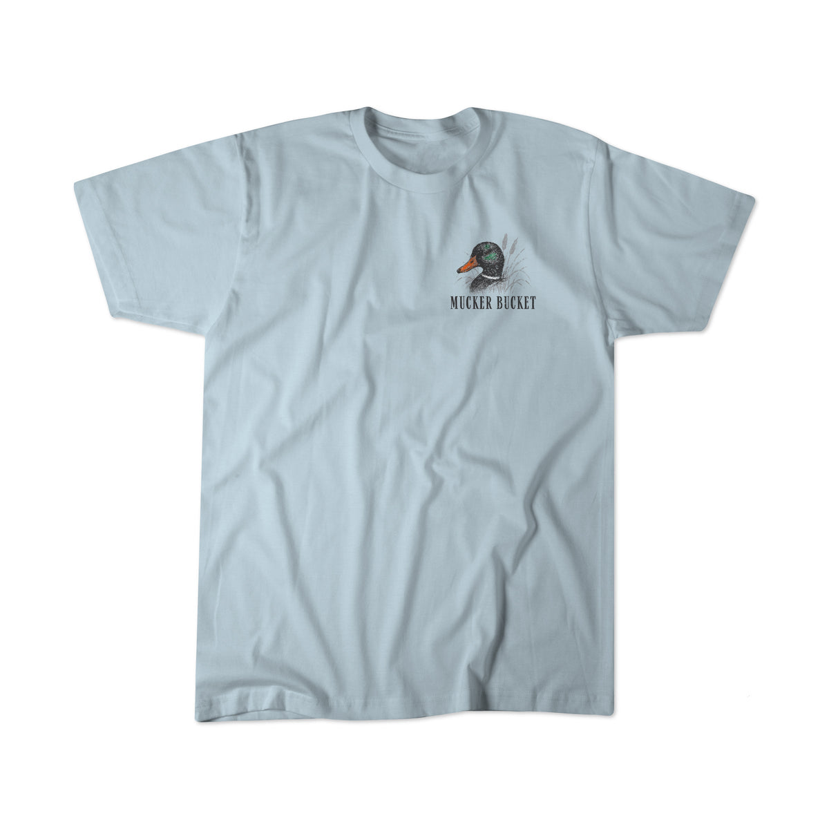The Duck DNA Premium Tee by Mucker Bucket is a light blue, garment-dyed, relaxed fit shirt with a small duck-in-a-bucket graphic and “MUCKER BUCKET” text on the left chest, laid flat on a white background.