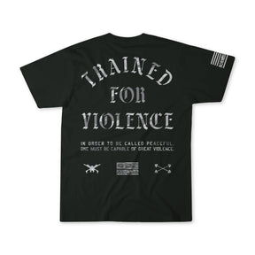 The Trained for Violence - Tee by Tango Charlie Apparel features bold TRAINED FOR VIOLENCE text, military-style graphics, and an American flag, with smaller print explaining that true peace needs psychological conditioning and strength.