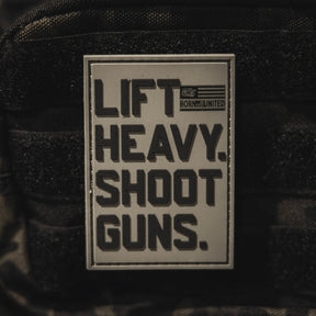 The LHSG - Patch by Tango Charlie Apparel is a rectangular 3D PVC Velcro patch with bold black "LIFT HEAVY. SHOOT GUNS." text, a small American flag, and "BORN UNITED." in the top right corner.